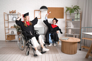 Canvas Print - Happy female graduate in wheelchair and classmate with diploma at home