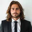 Stylish und incredible attractive man in suit and tie, long brown hair, white background