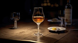 Fototapeta Lawenda - Wine glass with Calvados on a wooden table, dark background.