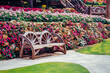 © Designpics - Close-up of a wagon wheel garden bench and flowerbeds; Chiang Rai, Thailand