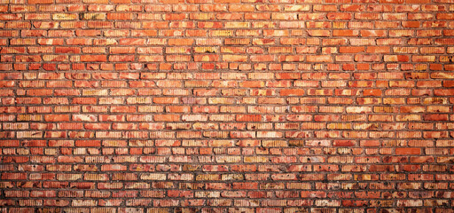 Wall Mural - old brick wall made of crumbling cobblestones, brickwork as background