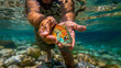hands holding a fish in the water, colorful fish, male hands releasing a fish in the water