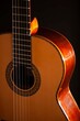 © Robert Peak - Classical Spanish flamenco guitar close up, dramatically lit isolated on black background with copy space.