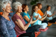 © pilipphoto - Group of senior women doing yoga exercise in studio