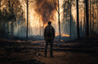 man with backpack standing in front of burnt down forest