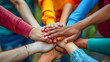 Group of multiethnic people holding hands on top of each other