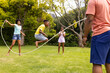 © Wavebreak Media - An African American family enjoys a sunny day playing with a jump rope outdoors
