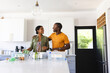 © Wavebreak Media - A diverse couple doing recycling together in the kitchen at home