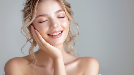 Canvas Print - Beautiful woman with blonde hair in elegant white dress touching her face and smiling, on white background, 