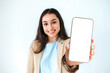 © Kateryna - Copy-space concept. Happy indian or arabian woman in elegant suit, showing smart phone with empty white mock-up screen for advertising, standing on isolated white background, looks at camera, smiling