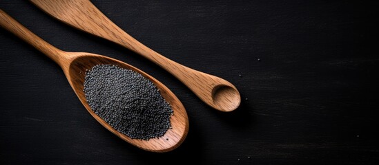 Wall Mural - Wooden spoons with black sesame seeds