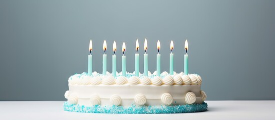 Wall Mural - Lit candles on a frosted cake