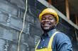 An upbeat construction worker with a yellow hard hat and safety vest poses at a construction site, radiating positivity