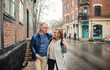 © Marko Geber - Happy mature couple walking and chatting on a city street