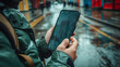 © Elena - Man holding mobile phonein a rainy day
