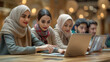 © Nataliia - Group of young muslim person using laptop computer. Helping refugees adapt to new place, temporary protection. Banner.
