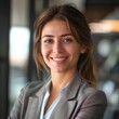 © serz72 - Smiling European businesswoman 20-30 years old, active business woman against the background of her office