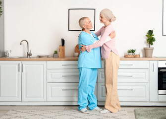 Poster - Young woman after chemotherapy hugging nurse at home. Stomach cancer concept