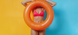 Fototapeta Tęcza - Portrait of a young woman relaxing with a rubber swimming pool ring on summer vacation