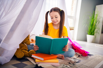 Poster - Photo portrait of charming small girl sit floor tent read book study lesson wear trendy yellow outfit children kindergarten playroom