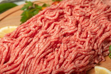 Wall Mural - Ground beef. Raw ground beef or minced meat on wood serving board. Close up