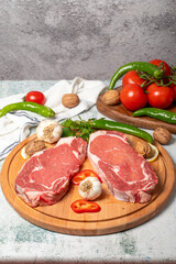 Canvas Print - Beef entrecote. Raw beef ribeye on wood serving board. Close up