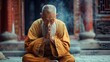 An elderly monk in orange robes meditates peacefully at a serene temple. The atmosphere is mystical with incense smoke. The monks calm demeanor and focused expression exude inner peace.