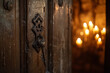 An antique wooden door slightly open, with an ornate key inserted in the keyhole, in a room filled with warm candlelight.