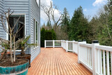 Fototapeta Tulipany - Freshly stain large home walk out cedar wood deck patio during early spring