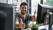 smiling young man working in a tech company showing thumbs up job satisfaction concept, happy worker showing thumbs up in office 
