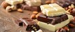 An assortment of chocolate bars with nuts on a rustic wooden surface, showcasing rich dark, creamy milk, and smooth white chocolates