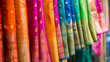 © amila - Close up portrait of colorful shiny indian saree hanging on a clothing rack