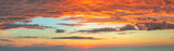 Fototapeta  - Dramatic sunrise against a sky with colorful clouds. Without any birds. Large panoramic photo. This is real dawn cloudscape