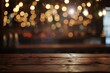 Empty wooden table with a blur of warm bokeh lights, setting the scene for a romantic or festive occasion