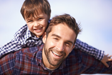 Poster - Portrait, man and child with piggy back, smile and playful travel to relax on outdoor adventure. Support, face of father and son in nature for fun bonding, playing and happy trust on holiday together