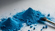 two piles of Vibrant Blue Powder with a make up brush