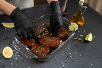 Wall Mural - marinated Pieces of Fresh tuna Fish fillet in glass cooking dish on a kitchen table