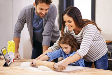 Wall Mural - Cooking, pizza and family in kitchen with tablet for recipe, guide and mom and dad learning with child. Teaching, baking and girl helping parents with rolling pin in home and together for dinner