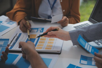 Close up ux developer and ui designer use augmented reality brainstorming about mobile app interface wireframe design on desk at modern office.Creative digital development agency