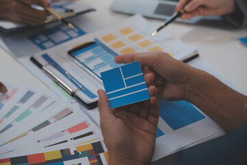 Close up ux developer and ui designer use augmented reality brainstorming about mobile app interface wireframe design on desk at modern office.Creative digital development agency