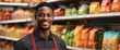 Male Black african grocery supermarket clerk worker employee on foods section smiling looking on camera, copy space banner template backdrop from Generative AI