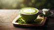 A steaming cup of matcha latte with latte art on top.