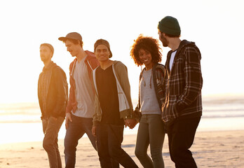 Wall Mural - Diverse, couple of friends and walk at beach with smile for bonding with holding hands, support, care and vacation in New York. People, talking and relax on summer holiday for adventure and happy