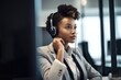 shot of a young businesswoman wearing headphones while on a call in an office