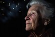 closeup of a senior woman at night looking out into the dark sky