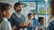 © Oulaphone - Teacher holding tablet computer explains to young children how wind turbines work in classroom. Kids Learning about eco-friendly forms of renewable energy.