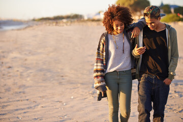 Wall Mural - Couple, walking and conversation together on beach, sunset with gen z people on nature date in summer. Love, affection and bonding for romantic relationship, happy partners on relaxing vacation