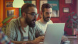 © Oulaphone - Male hipster entrepreneurs working with laptop at desk in creative office.