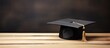 © Ilgun - A graduation cap on a wooden table