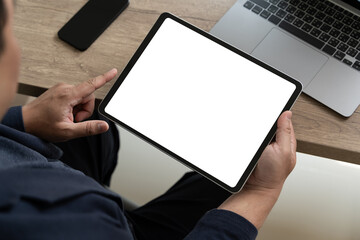 A businessman holds a mockup. iPad digital tablet with blank screen Mockup replaces your design mockup in the office.